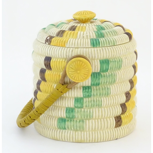 77 - A Clarice Cliff biscuit jar / barrel with swing handle in the Raffia pattern. Marked Bizarre by Clar... 