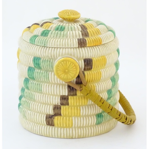 77 - A Clarice Cliff biscuit jar / barrel with swing handle in the Raffia pattern. Marked Bizarre by Clar... 