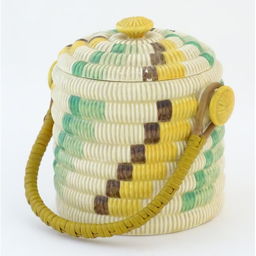 77 - A Clarice Cliff biscuit jar / barrel with swing handle in the Raffia pattern. Marked Bizarre by Clar... 