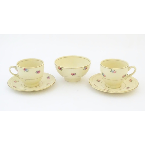 79 - A quantity of Clarice Cliff tea wares with floral decoration and gilt highlights, comprising two tea... 