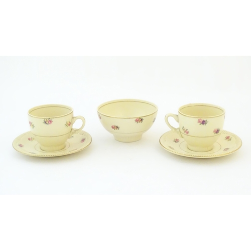 79 - A quantity of Clarice Cliff tea wares with floral decoration and gilt highlights, comprising two tea... 