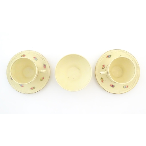 79 - A quantity of Clarice Cliff tea wares with floral decoration and gilt highlights, comprising two tea... 