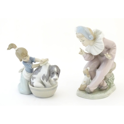 82 - A Lladro model Bashful Bather, no. 5455, depicting a girl washing a dog. Together with a Nao figure ... 