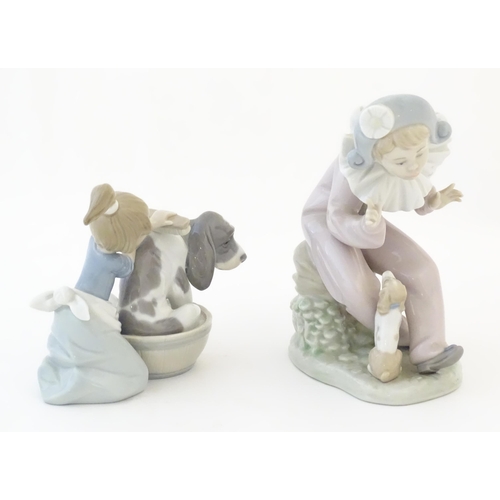 82 - A Lladro model Bashful Bather, no. 5455, depicting a girl washing a dog. Together with a Nao figure ... 