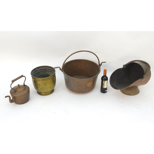 145 - An assortment of brass and copper items, comprising a large stove pan, a helmet coal scuttle, a log ... 