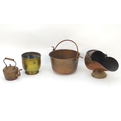 145 - An assortment of brass and copper items, comprising a large stove pan, a helmet coal scuttle, a log ... 