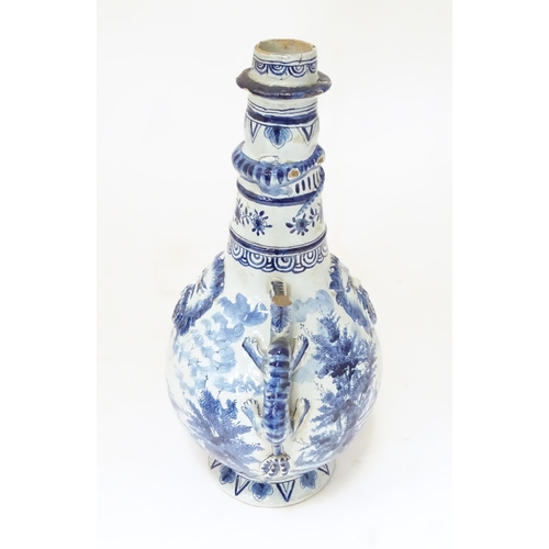 156 - A Continental blue and white bottle vase with twin zoomorphic handles, relief mask detail and relief... 