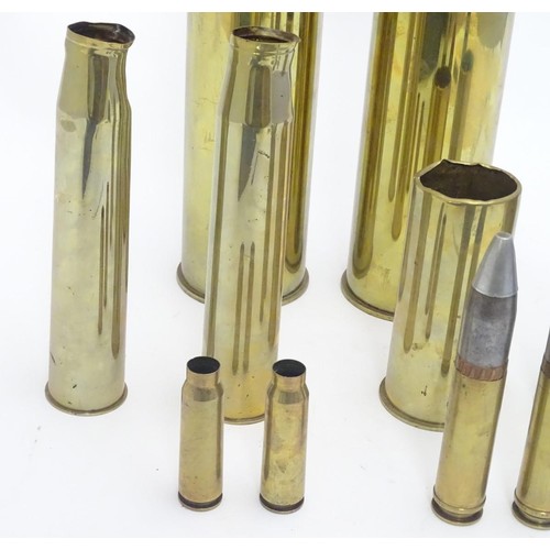 159 - Militaria: an array of 20thC artillery and cannon shell cases, including M14s, 37-25 anti-tank, airc... 