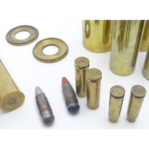 159 - Militaria: an array of 20thC artillery and cannon shell cases, including M14s, 37-25 anti-tank, airc... 