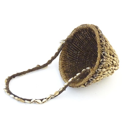 160 - Ethnographic / Native / Tribal: A woven basket with cowrie shell detail and loop handle. Basket appr... 