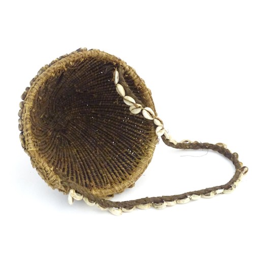 160 - Ethnographic / Native / Tribal: A woven basket with cowrie shell detail and loop handle. Basket appr... 