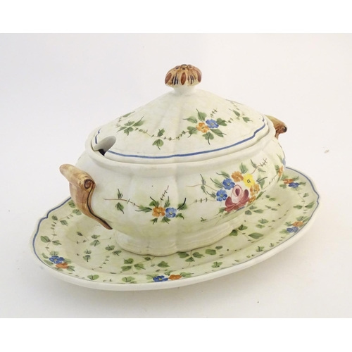 175 - A French twin handled lidded tureen and stand with hand painted floral and foliate detail. Marked un... 