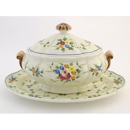 175 - A French twin handled lidded tureen and stand with hand painted floral and foliate detail. Marked un... 