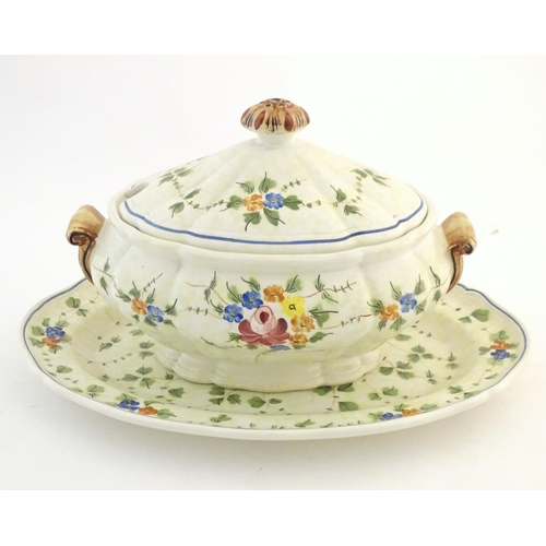 175 - A French twin handled lidded tureen and stand with hand painted floral and foliate detail. Marked un... 