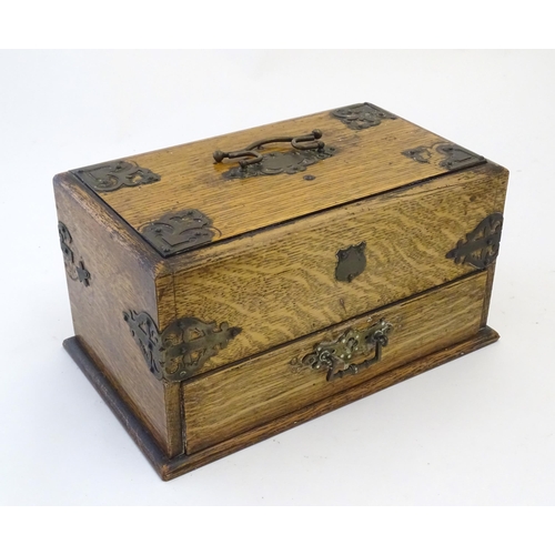 199 - A Victorian oak smokers companion box with applied mounts and handles, opening to reveal various com... 