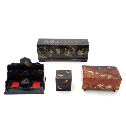 203 - Four Oriental lacquered items comprising a desk tidy / organiser with shaped back decorated with a w... 