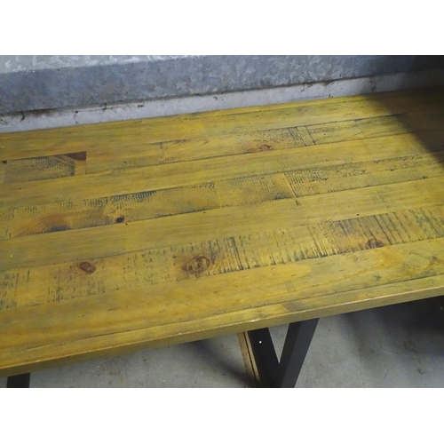 215 - A modern coffee table with metal supports. Approx. 43 1/2