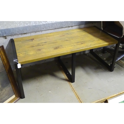 215 - A modern coffee table with metal supports. Approx. 43 1/2