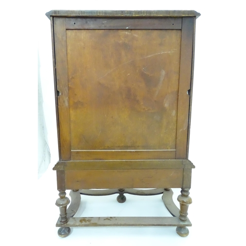 217 - A William and Mary style pier cabinet with glazed door. Approx 40