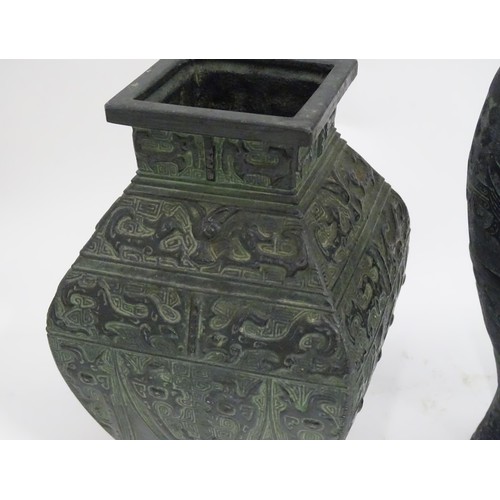 184 - Two Oriental cast vases with stylised animal decoration