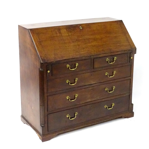 241 - A large late 18thC mahogany bureau, having a fall front opening to show a fitted interior above two ... 