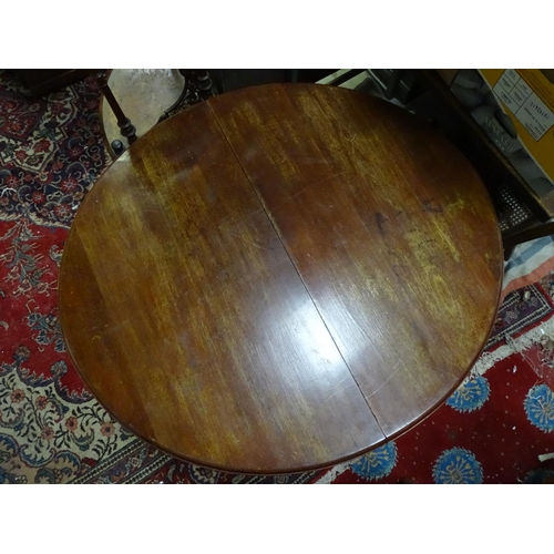 265 - A mahogany oval dining table with cabriole legs and pad feet. Approx 45 3/4