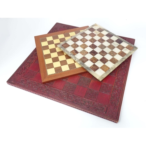 272 - Toys: Three assorted chess / draughts boards to include a carved wood and a hardstone example. The l... 