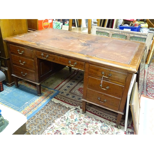 281 - Large early 20thC mahogany desk with leather insert to top and  standing on 8 legs with brass caster... 