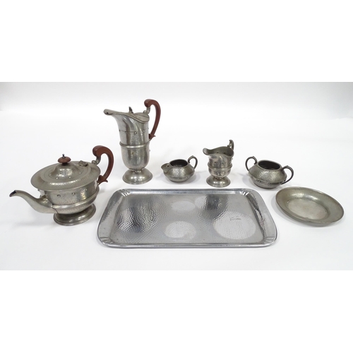 1 - A quantity of Arts & Crafts style pewter tea wares with hammered decoration comprising teapot, milk ... 