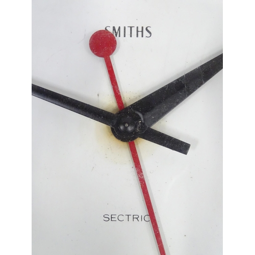 106 - Mid 20thC Smiths sectric Bakelite clock together with an Art Deco style tin plate enamel painted wal... 