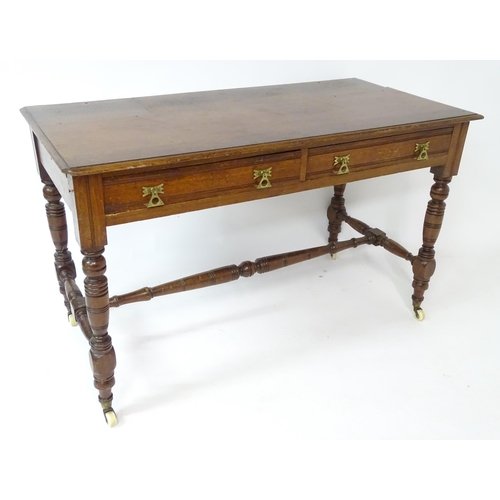 133 - Mahogany aesthetic movement writing desk with moulded top above two short drawers and raised on four... 