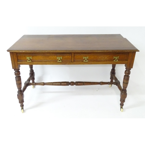 133 - Mahogany aesthetic movement writing desk with moulded top above two short drawers and raised on four... 