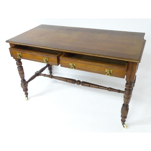 133 - Mahogany aesthetic movement writing desk with moulded top above two short drawers and raised on four... 