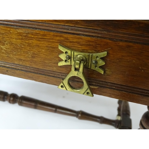 133 - Mahogany aesthetic movement writing desk with moulded top above two short drawers and raised on four... 