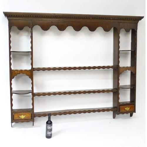 234 - A Georgian oak plate rack with moulded cornice above dental carved frieze. Approx 70