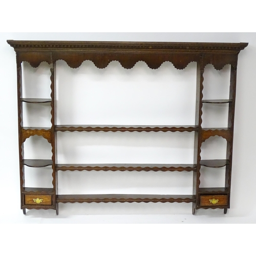 234 - A Georgian oak plate rack with moulded cornice above dental carved frieze. Approx 70