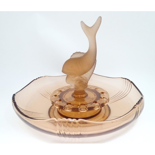 92 - An Art Deco glass centrepiece with glass bowl, flower holder and central fish / dolphin . In the man... 