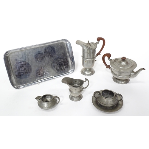 1 - A quantity of Arts & Crafts style pewter tea wares with hammered decoration comprising teapot, milk ... 