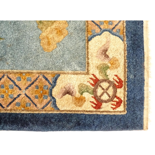 230 - A Chinese rug, the blue ground decorated with dragons, bordered by further dragons and Oriental moti... 