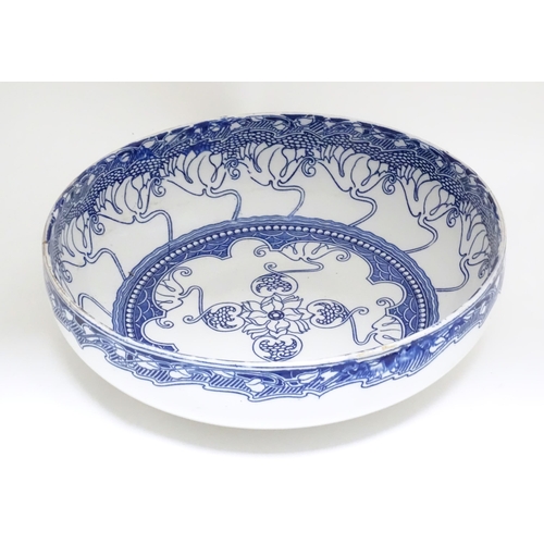 299 - A large blue and white Doulton Burslem bowl in the Kelmscot pattern with Art Nouveau detail. Marked ... 