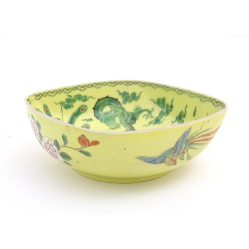 1099 - A Chinese famille jaune yellow bowl of oblong form decorated with green dragons among stylised cloud... 