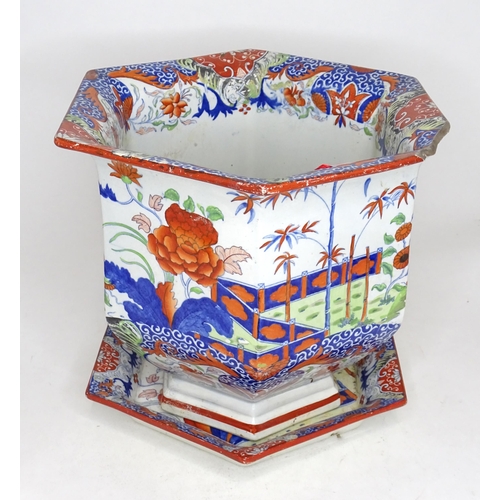 1102 - A hexagonal jardiniere / planter and stand with Chinese style decoration with flowers and foliage. A... 