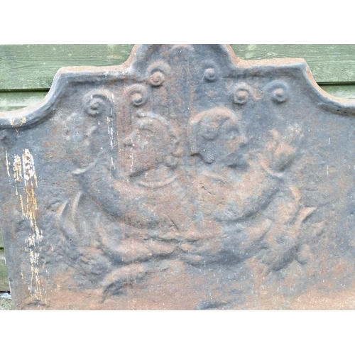 1385 - A 19thC continental cast iron fireback, decorated with opposing figures and with a raised border. Ap... 