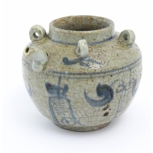 1 - An Oriental stoneware water pot / jar with four loop handles, a spout and crackle glaze with blue br... 