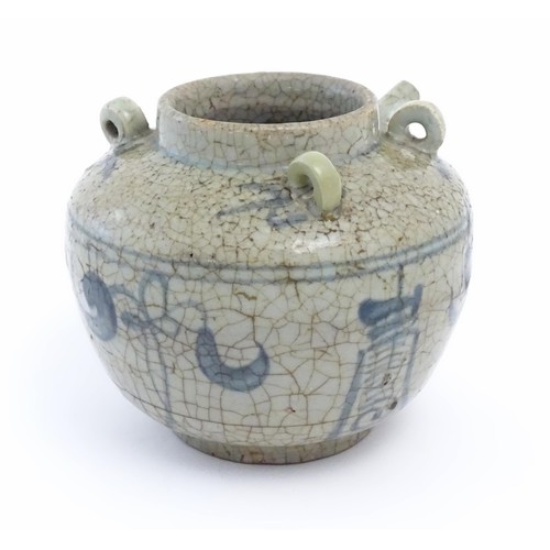 1 - An Oriental stoneware water pot / jar with four loop handles, a spout and crackle glaze with blue br... 
