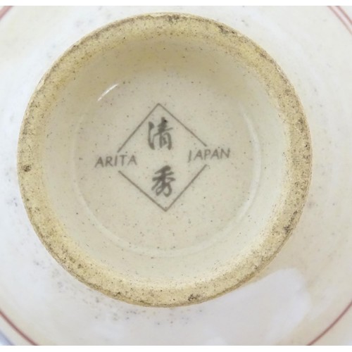 23 - Three Japanese tea bowls with roundel detail. Marked Arita Japan under. Approx. 2 1/4