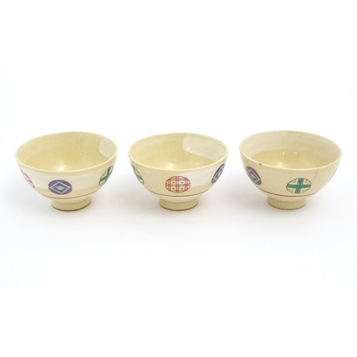 23 - Three Japanese tea bowls with roundel detail. Marked Arita Japan under. Approx. 2 1/4