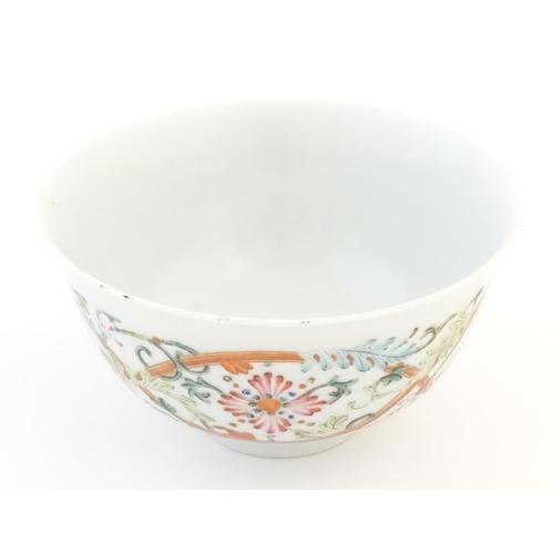 24 - A small Chinese famille rose bowl decorated with scrolling floral and foliate detail, and bat detail... 