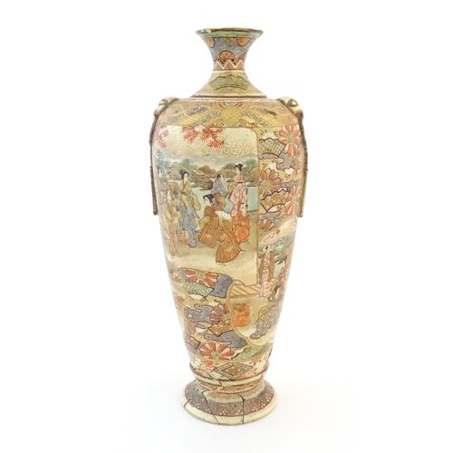 27 - A Japanese satsuma vase with relief twin handles and panelled decoration depicting figures in landsc... 