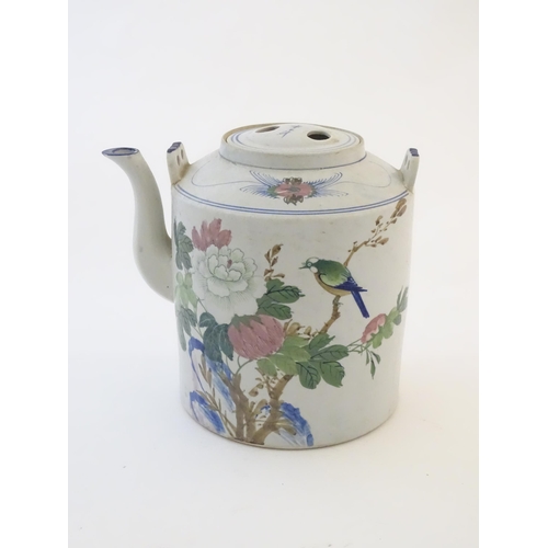 43 - A large Oriental teapot decorated with flowers, foliage and a bird, with scrolling brushwork detail.... 
